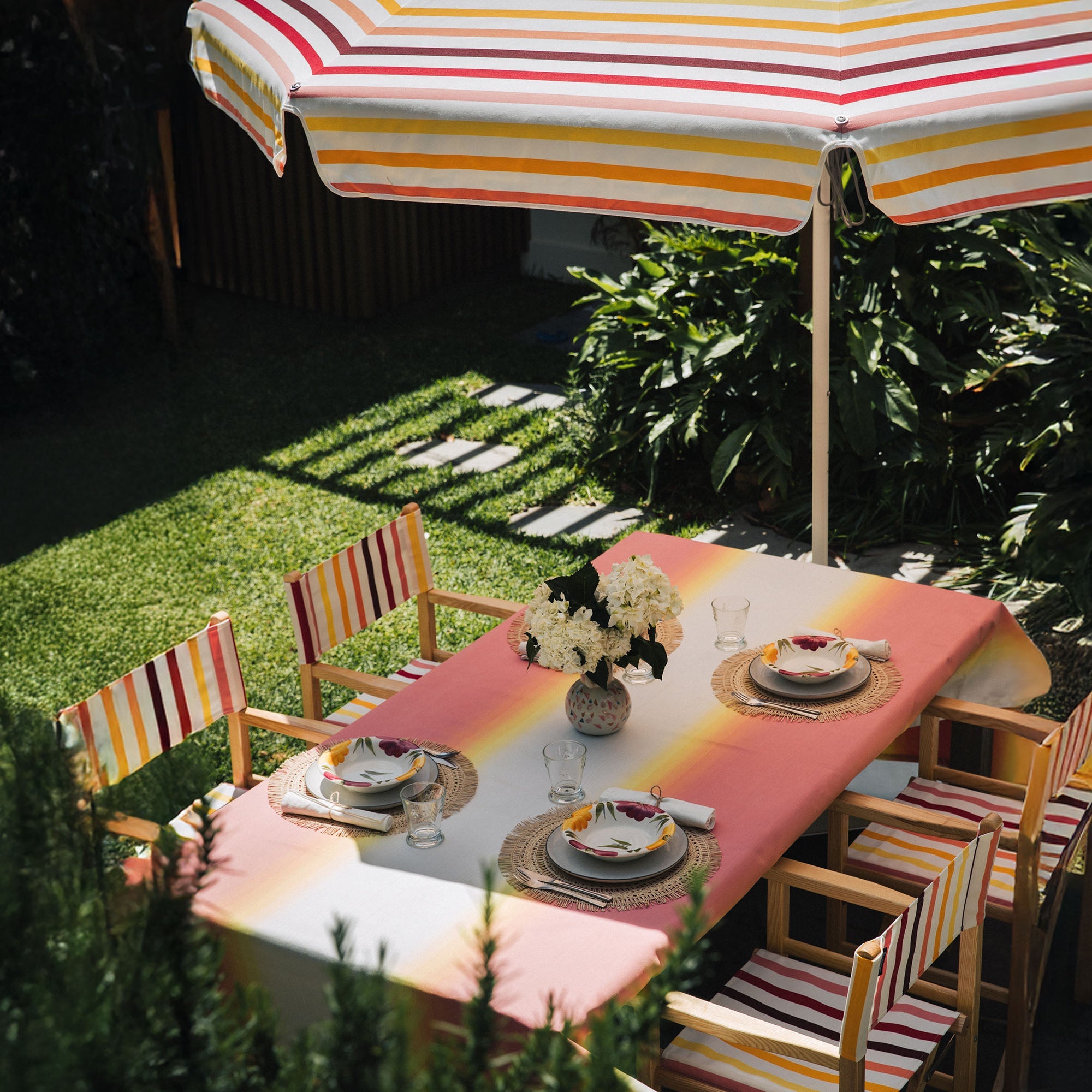 Basil Bangs table setting in pink, orange and yellow ombres