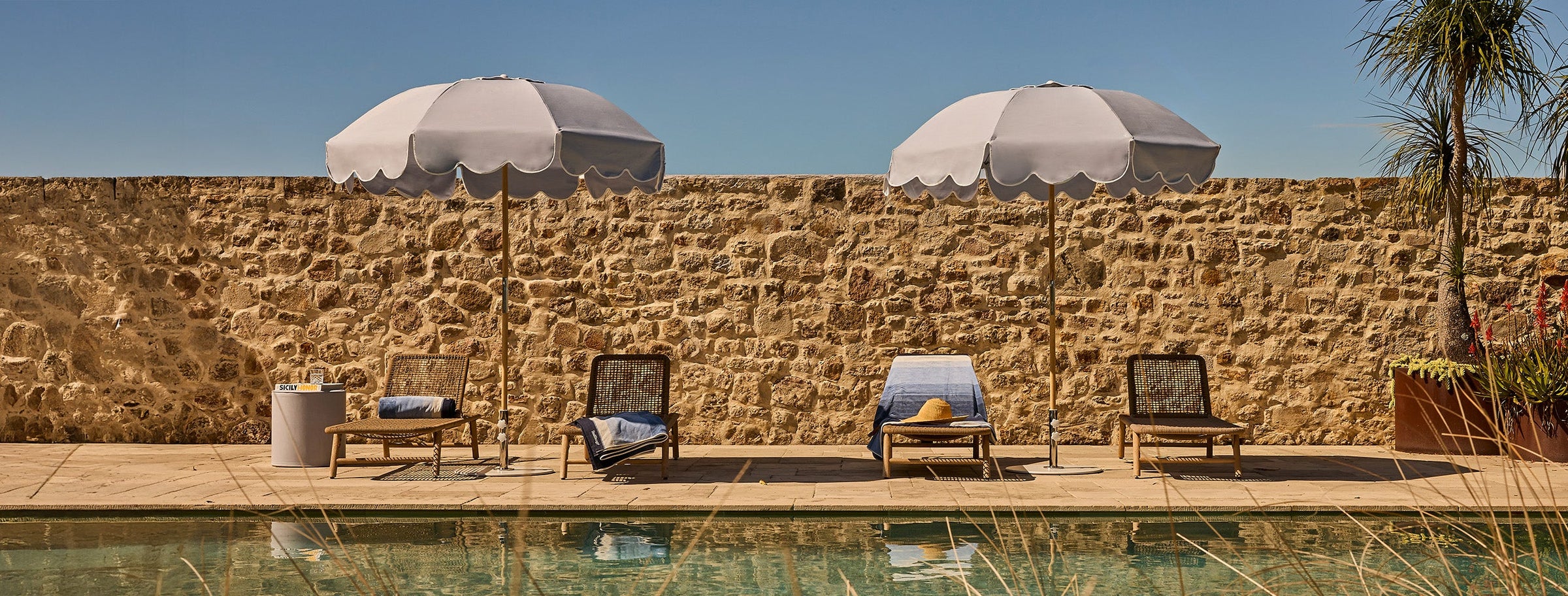Basil Bangs Terra Ombre Jardin Umbrella on the pontoon at Lilypad Palm Beach with deck chairs and cushions.