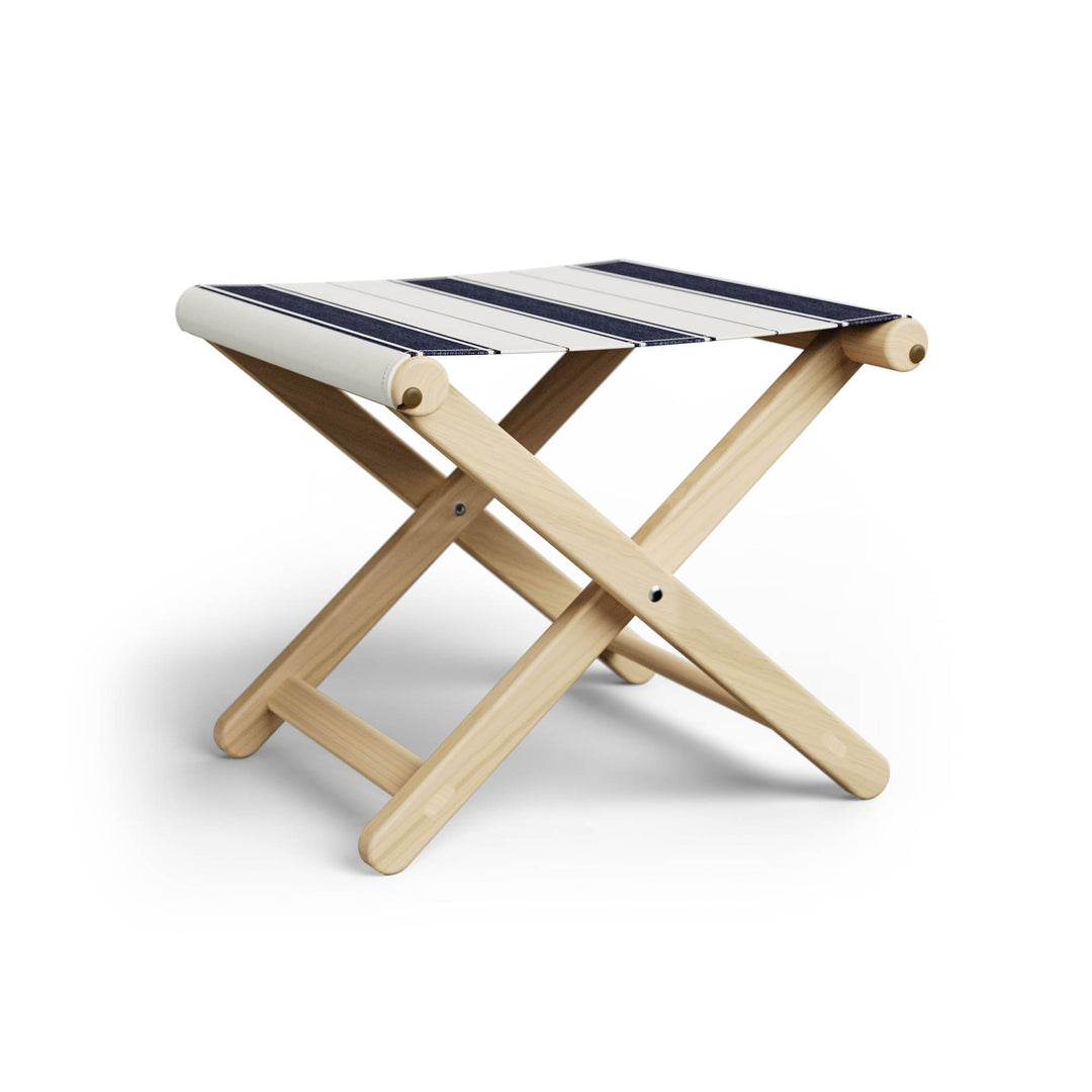 Basil Bangs Footstool, a portable outdoor footrest with a solid European Ash timber frame and outdoor acrylic fabric sling