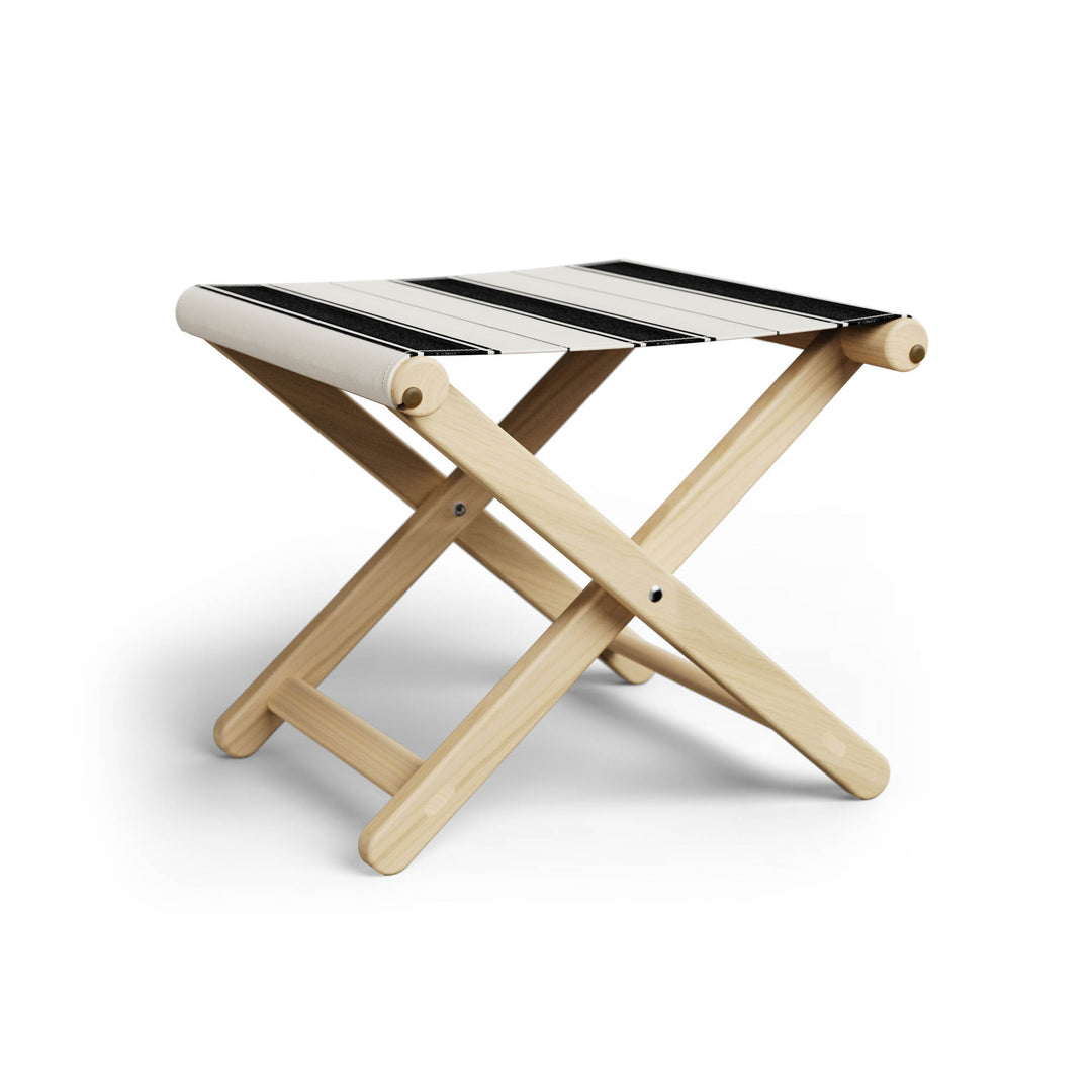 Basil Bangs Footstool, a portable outdoor footrest with a solid European Ash timber frame and outdoor acrylic fabric sling