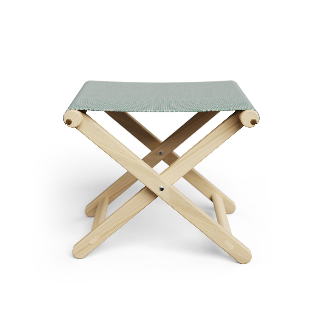 Basil Bangs Footstool, a portable outdoor footrest with a solid European Ash timber frame and outdoor acrylic fabric sling