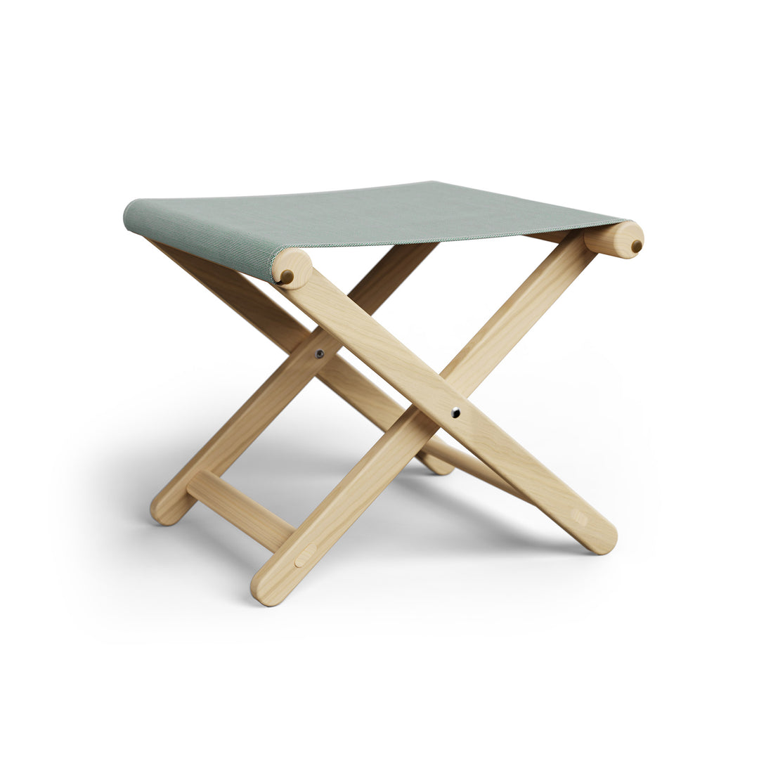 Basil Bangs Footstool, a portable outdoor footrest with a solid European Ash timber frame and outdoor acrylic fabric sling