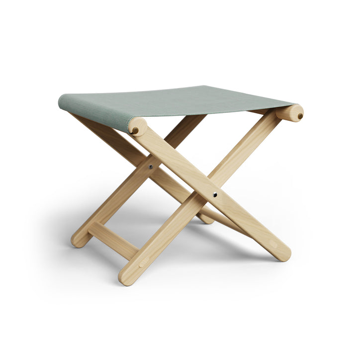 Basil Bangs Footstool, a portable outdoor footrest with a solid European Ash timber frame and outdoor acrylic fabric sling