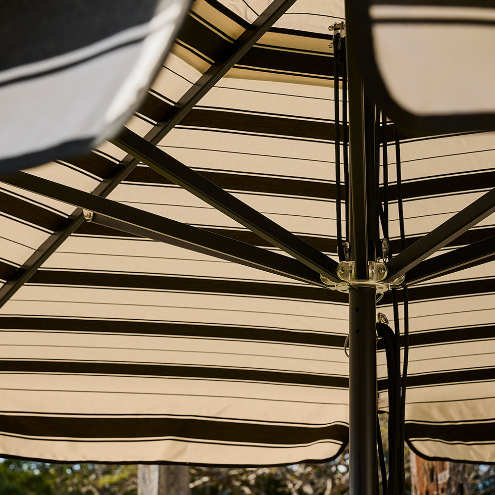 Basil Bangs commercial and residential black frame patio umbrella with black Al Mare stripe canopy