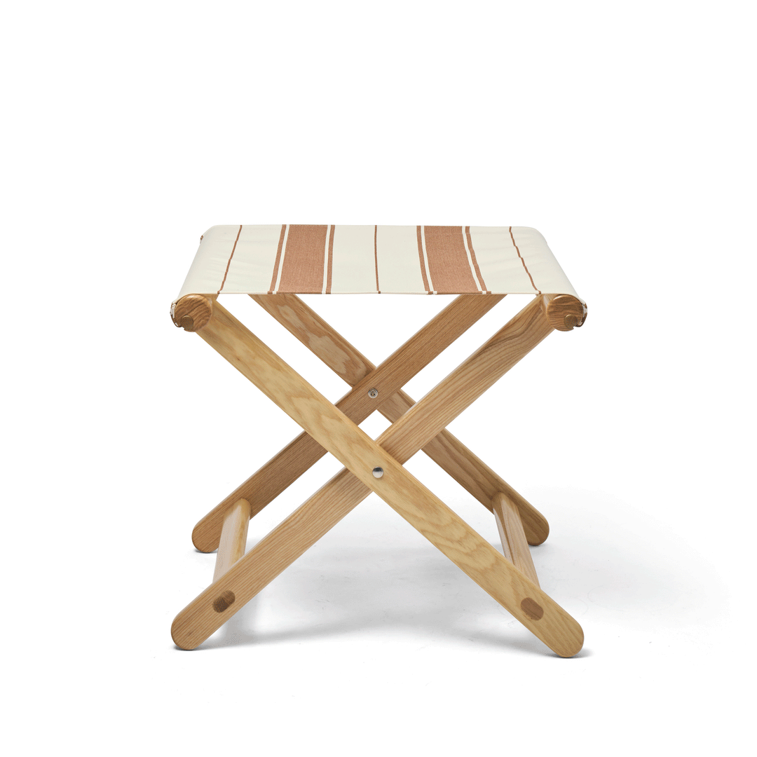 Basil Bangs Footstool folding animation. A portable outdoor footrest with a solid European Ash timber frame and outdoor acrylic fabric sling.