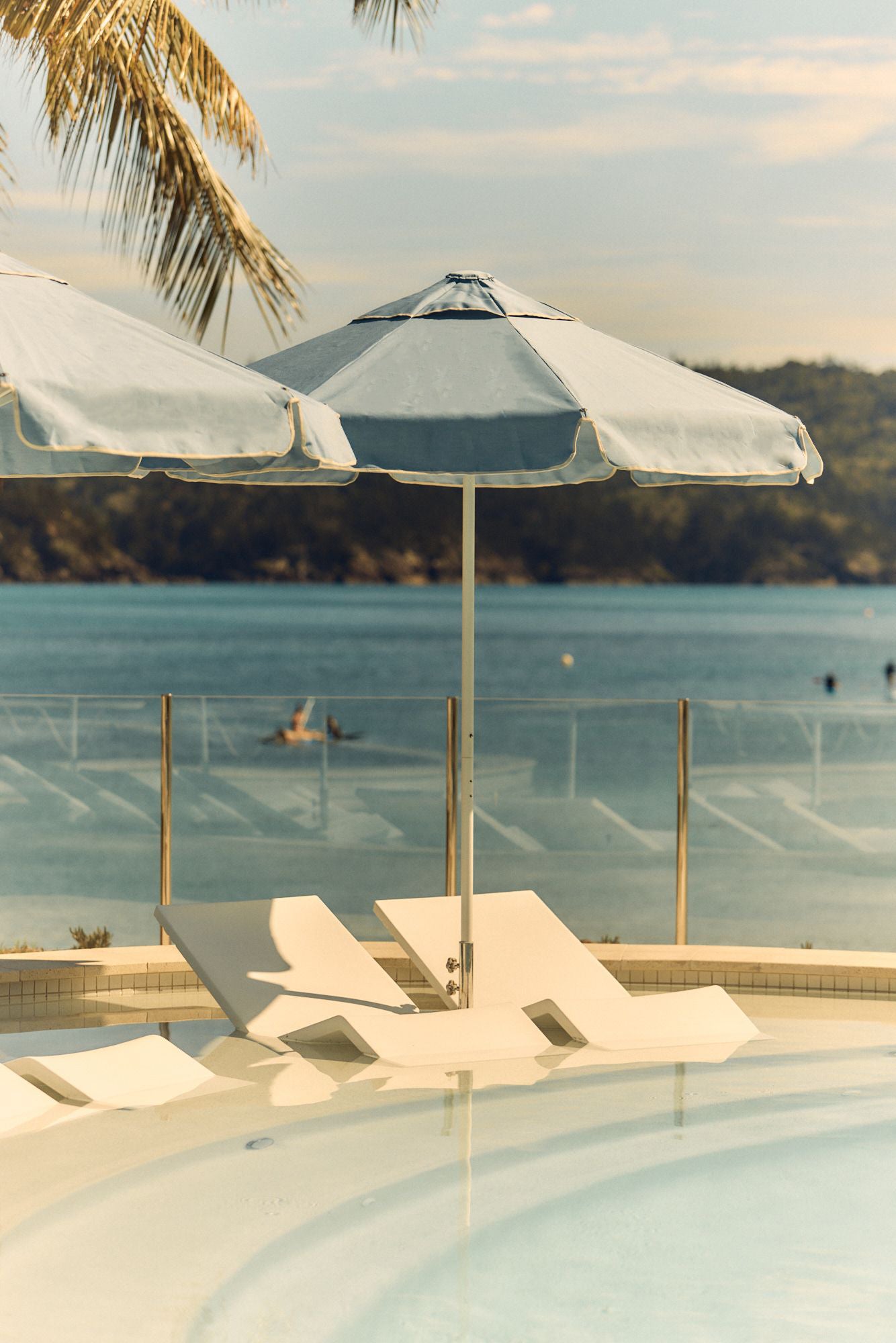 The Sails Pool Hamilton Island with Basil Bangs Blue Sundial Umbrella